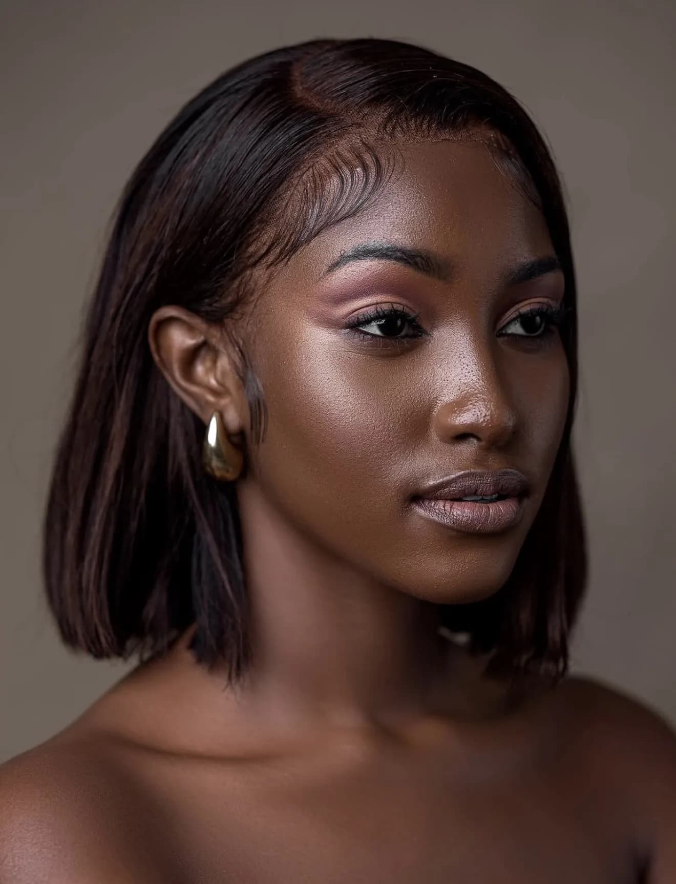 A woman with a dark bob turning away from the camera