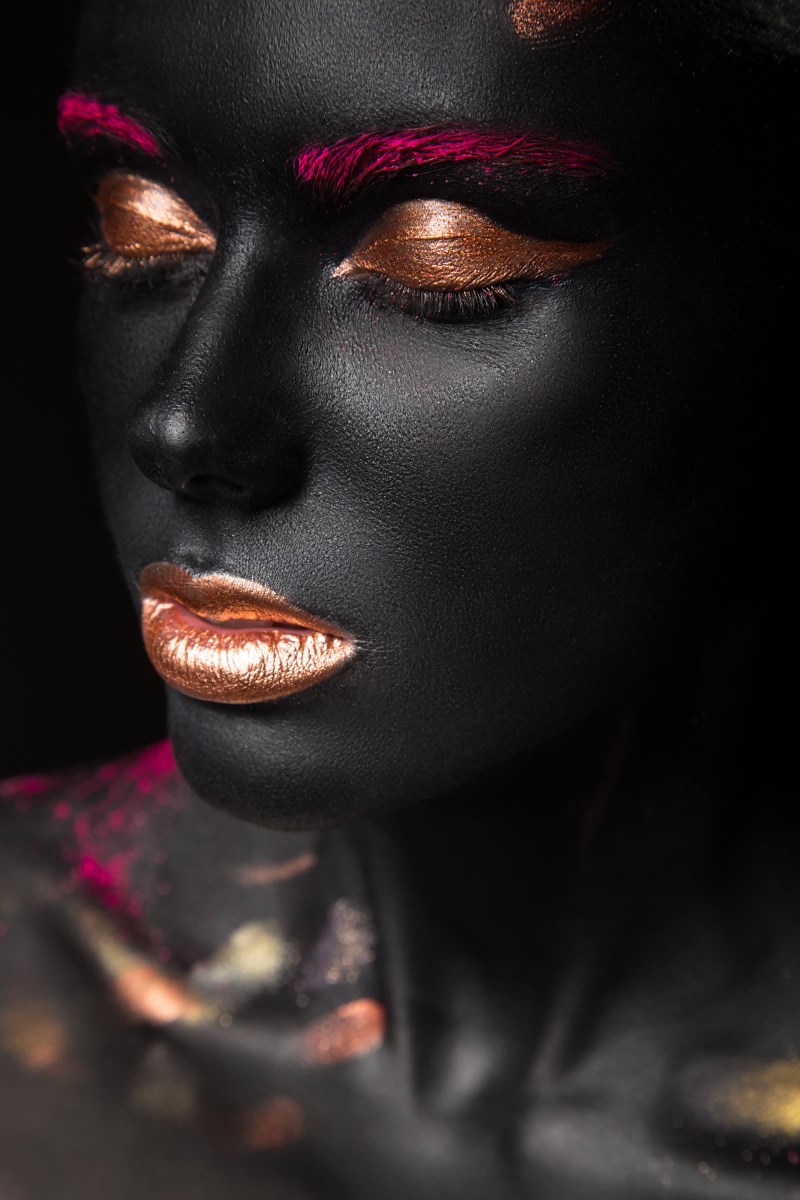 A dramatic beauty portrait in black and gold