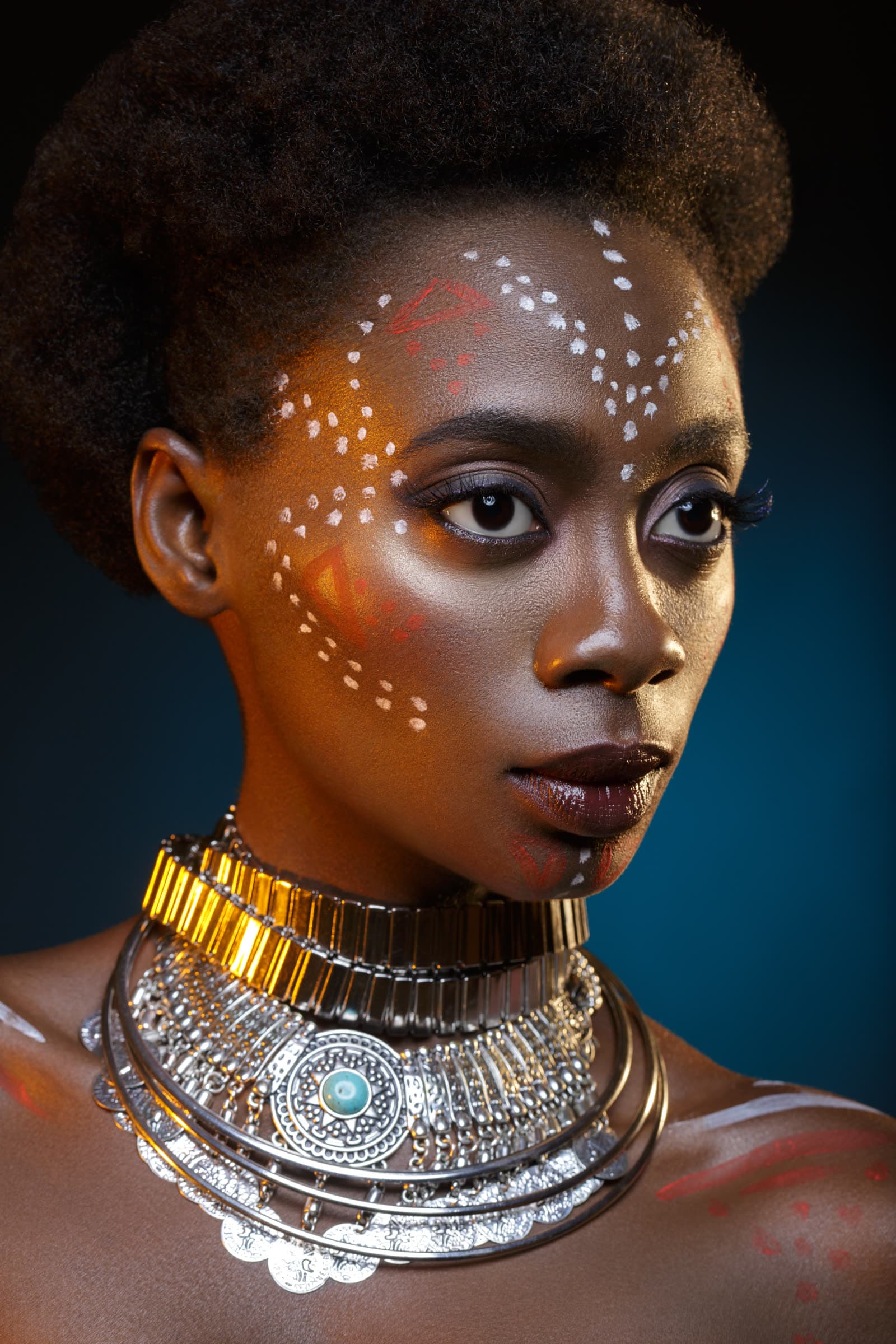 A Tanzanian woman in traditional makeup and jewellery